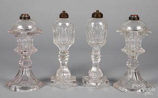 Two pairs of colorless glass whale oil lamps