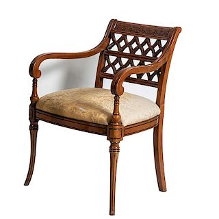 Sillón. Siglo XX. Estilo Regencia. Estructura de madera tallada. Con asiento acojinado de tela.