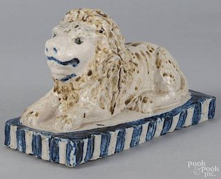 Pennsylvania or Ohio stoneware recumbent lion, 19th c., with cobalt highlights