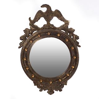 Espejo. Con marco de madera dorada y luna circular convexa. Decorado con molduras, elementos vegetales y remate a manera de águila.