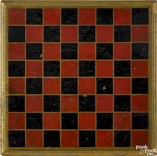 Painted pine gameboard, ca. 1900, retaining its original red and black squares on a gilt ground