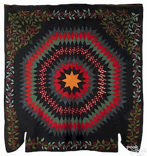 Vibrant radiant star quilt, 19th c., with a trailing vine and berry border, probably New England