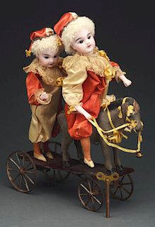 Two Bisque Headed Doll, One Sitting On Donkey Pull Toy. 