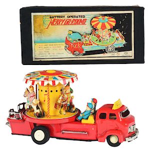 Tin Litho Battery Operated Merry Go Round Truck.