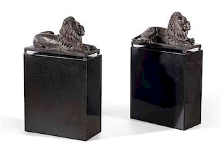 A pair of  bronze figures of recumbent lions