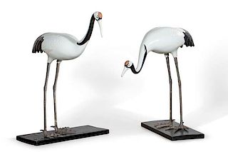 A pair of porcelain and  metal standing cranes