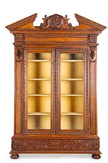 A Renaissance Revival carved display cabinet