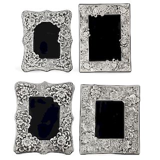 Four silver floral decorated  picture frames