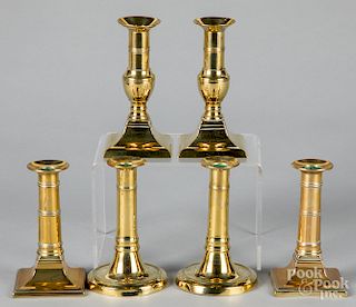 Three pairs of English brass candlesticks