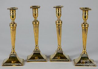 Four English brass candlesticks