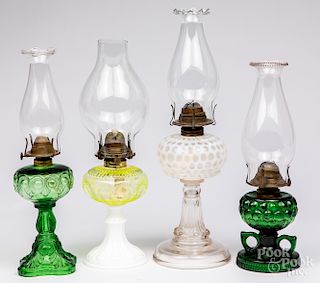 Four glass kerosene lamps.
