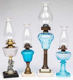 Four glass kerosene lamps.