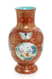 * A Gilt Decorated Iron Red Ground Famille Rose Porcelain Vase Height 9 3/4 inches.