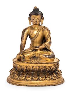 A Sino-Tibetan Gilt Bronze Figure of Shakyamuni Buddha Height 5 1/4 inches.