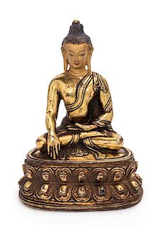A Sino-Tibetan Gilt Bronze Figure of Shakyamuni Buddha Height 6 inches.