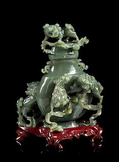 * A Spinach Jade 'Fu Lion' Vase and Cover Height 8 inches.