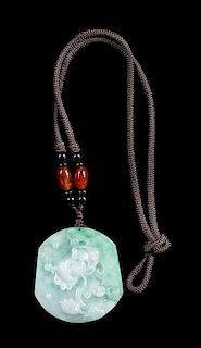 A Celadon and White Jadeite 'Lotus' Pendant Length 2 inches.