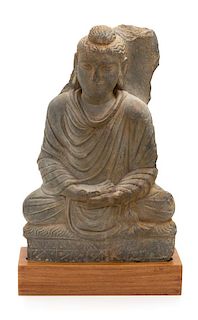 A Gandharan Gray Schist Figure of Seated Buddha Height 15 1/4 inches.