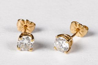 Pair of 14K yellow gold diamond stud earrings