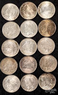 Fifteen Peace silver dollars.