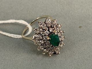 14k white gold cocktail ring set with center emerald surrounded by thirty-nine diamonds. size 6 1/4