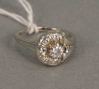 18 karat white gold ring set with center diamond, approximately .50 cts with six diamonds around. size 6 1/2
