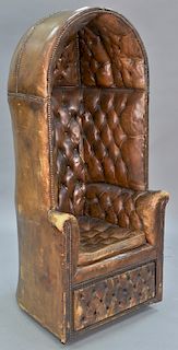 Leather tufted hooded chair with storage door in base. ht. 69 in., wd. 31 in.