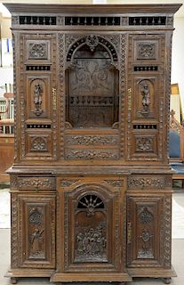 Continental oak two part cabinet having three dimensional figures, 19th century. ht. 96 1/2 in., wd. 60 in. Provenance: From an estat...