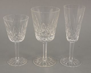 Twenty-one piece Waterford crystal group to include seven wine glasses, six water, four champagne, compote, small vase (ht. 4 1/4 in...
