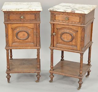 Pair of marble top oak stands. ht. 33 1/2 in., top: 16 1/2" x 16 1/2" Provenance: From an estate in Lloyd Harbor, Long Island, New York