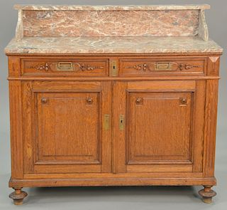 Continental oak server with marble top. ht. 35 in., wd. 46 in. Provenance: From an estate in Lloyd Harbor, Long Island, New York