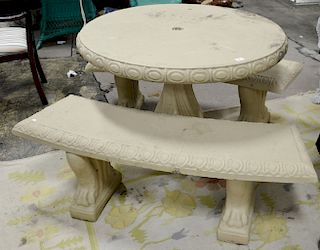 Three piece lot to include a cement round table and two carved benches. table: ht. 30 in., dia. 42 in.; bench: 51 1/2 in.