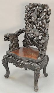 Carved Oriental armchair with carved monkeys and fruit. ht. 48 1/2 in.