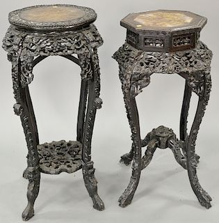 Two Chinese carved stand with inset marble tops. ht. 34 1/2 in. and ht. 37 in. Provenance: From an estate in Lloyd Harbor, Long Isla...