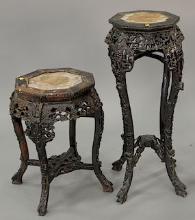Two Chinese teak stands with inset marble tops. ht. 24 in. & ht. 36 in. Provenance: From an estate in Lloyd Harbor, Long Island, New...