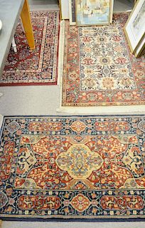 Four Oriental style throw rugs, one is a Karastan. 3'9" x 5', 4' x 6', 2'9" x 5', and 2'6" x 4'
