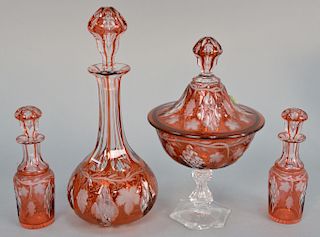 Ten piece lot of cranberry cut to clear three decanters, three covered compotes, and four pieces from castor set. ht. 4 in. to 12 1/...