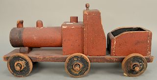 Large ride on toy train engine with coal car, original red paint. ht. 16 1/2 in., lg. 35 in. Provenance: From an estate in Lloyd Har...