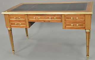 Louis XVI style writing table with brass trim and inset leather top with two pull out slides. ht. 29 in., top: 24" x 59"