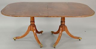 Mahogany double pedestal dining table with two 24'' leaves.. ht. 28 1/2 in., top: 44" x 68"