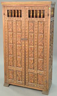 Carved two door cabinet. ht. 69 in., wd. 39 in.