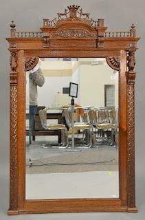 Continental oak mirror with carved figures. 61" x 40" Provenance: From an estate in Lloyd Harbor, Long Island, New York