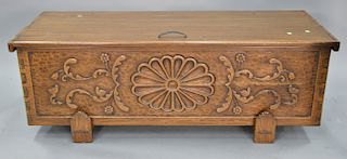 Cedar lined lift top chest with carved front. ht. 22 in., wd. 60 in.