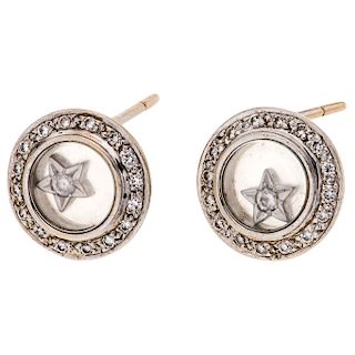 A diamond 18K white gold pair of stud earrings.