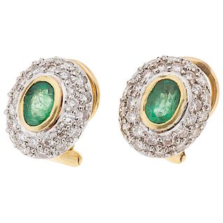 An emerald and diamond 18K yellow gold pair of earrings.