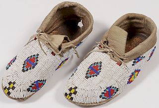 A PAIR OF BEADED PLAINS MOCCASINS, 20TH C