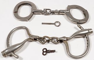 A PAIR OF VINTAGE HANDCUFFS