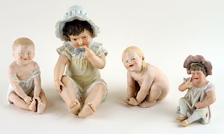 FOUR CONTINENTAL PORCELAIN PIANO BABY FIGURES