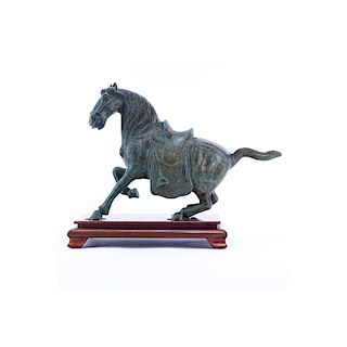 Chinese Tang Dynasty Style Patinated Bronze Model of a Horse on Wooden Stand. Rubbing to surface, s