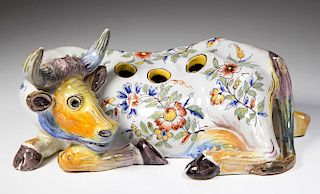 CONTINENTAL FAIENCE FIGURAL FLOWER-HOLDER IN THE FORM OF A RECUMBENT COW